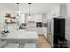 Modern white kitchen with stainless steel appliances, quartz countertops, and ample cabinet space at 103 W Sunset Dr, Locust, NC 28097