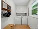 Well-lit laundry room with white washer and dryer, complemented by neutral decor and a window at 103 W Sunset Dr, Locust, NC 28097