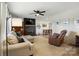 Cozy living room with a fireplace, ceiling fan, and comfortable seating at 103 W Sunset Dr, Locust, NC 28097