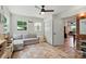 Comfortable playroom features a gray sectional sofa, patterned rug, and storage at 103 W Sunset Dr, Locust, NC 28097