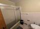 A bathroom with white tile at 116 E Graves St, Candor, NC 27229