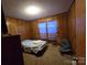 A bedroom with paneled walls at 116 E Graves St, Candor, NC 27229