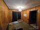 A bedroom with paneled walls and carpet at 116 E Graves St, Candor, NC 27229