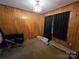 A bedroom with paneled walls and carpet at 116 E Graves St, Candor, NC 27229
