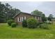 A charming brick home features lush landscaping and a well-maintained yard at 116 E Graves St, Candor, NC 27229
