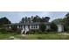 Charming brick home featuring a well-maintained lawn and mature trees in a quiet neighborhood at 116 E Graves St, Candor, NC 27229