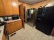 Kitchen with wooden cabinetry and stainless steel refrigerator at 116 E Graves St, Candor, NC 27229