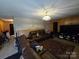 Cozy living room with wood paneling, a plush leather sofa, and a patterned rug at 116 E Graves St, Candor, NC 27229