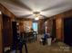 Spacious living area with a ceiling fan, wood paneling, and sliding glass doors to the exterior at 116 E Graves St, Candor, NC 27229