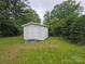 A sturdy white shed offers extra storage space and complements the property at 116 E Graves St, Candor, NC 27229