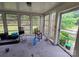 Sunroom with walls of windows offering picturesque views of the surrounding greenery at 116 E Graves St, Candor, NC 27229