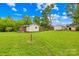 Expansive backyard featuring lush green grass and storage sheds, offering ample outdoor space and practical storage solutions at 119 Oak Ave, Shelby, NC 28152