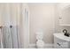 Cozy bathroom with a white toilet, vanity, and shower curtain, complete with updated fixtures and lighting at 119 Oak Ave, Shelby, NC 28152
