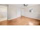 Bright bedroom with hardwood floors, a ceiling fan, and neutral walls, creating a comfortable and inviting space at 119 Oak Ave, Shelby, NC 28152