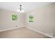 Cozy bedroom with neutral walls, two windows and carpeted floors providing a comfortable and serene atmosphere at 119 Oak Ave, Shelby, NC 28152