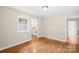Well-lit bedroom with hardwood floors, a window, and neutral walls, creating a relaxing and comfortable living space at 119 Oak Ave, Shelby, NC 28152