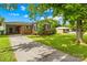 Charming brick home with a well-manicured lawn, mature trees, and a long driveway, offering a welcoming curb appeal at 119 Oak Ave, Shelby, NC 28152