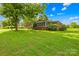 Landscaped front yard with lush green lawn and mature trees surrounding this charming brick home at 119 Oak Ave, Shelby, NC 28152