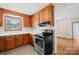 Well-maintained kitchen featuring wooden cabinets, white countertops, and stainless steel appliances at 119 Oak Ave, Shelby, NC 28152