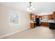 Kitchen featuring wooden cabinets, white countertops, and stainless steel appliances with dining area at 119 Oak Ave, Shelby, NC 28152