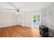 Hardwood floored living room showcasing a brick fireplace, built-in shelving, and a ceiling fan at 119 Oak Ave, Shelby, NC 28152