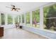 Inviting sunroom featuring multiple windows providing natural light and a ceiling fan for comfort at 119 Oak Ave, Shelby, NC 28152