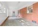 Sunroom enclosed with brick and glass features a concrete floor, ample natural light and a door leading outside at 119 Oak Ave, Shelby, NC 28152
