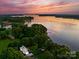 Scenic aerial view of waterfront property with lush greenery and breathtaking sunset at 138 Lakefront Dr, Mooresville, NC 28117