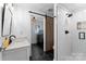 Modern bathroom featuring a walk-in shower and laundry room through barn door at 138 Lakefront Dr, Mooresville, NC 28117