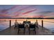 Outdoor seating on a wooden dock overlooking water with amazing sunset views at 138 Lakefront Dr, Mooresville, NC 28117