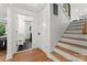 Bright home foyer featuring wood floors, a staircase, and open doorway to the bathroom at 138 Lakefront Dr, Mooresville, NC 28117