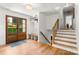 Bright foyer featuring wood floors, stairs, and a conveniently placed coat rack at 138 Lakefront Dr, Mooresville, NC 28117