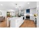 Modern kitchen and living area features an island with seating and stainless steel appliances at 138 Lakefront Dr, Mooresville, NC 28117