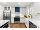 Well-lit kitchen boasts sleek white cabinetry, stainless steel appliances, and stylish countertops at 138 Lakefront Dr, Mooresville, NC 28117