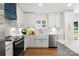 Bright kitchen with modern appliances, a farmhouse sink, and a beautiful countertop at 138 Lakefront Dr, Mooresville, NC 28117