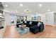 Spacious living room featuring a large blue sectional and views of the lake at 138 Lakefront Dr, Mooresville, NC 28117