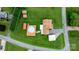 Aerial view of a home with mature trees surrounding the property, a pool, storage buildings, and large green lawn at 139 Pleasant Garden Dr, Taylorsville, NC 28681