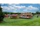 Spacious backyard featuring a pool with a deck and outbuildings, all enclosed by a chain-link fence at 139 Pleasant Garden Dr, Taylorsville, NC 28681