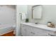 Bright bathroom features a single sink vanity, modern faucet, and updated countertop with a walk-in shower and modern fixtures at 139 Pleasant Garden Dr, Taylorsville, NC 28681