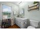 Bathroom features a single sink vanity with updated fixtures and a large mirror. It's well-lit and has shelving for storage at 139 Pleasant Garden Dr, Taylorsville, NC 28681