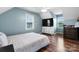 This bedroom has light blue walls, beautiful flooring, and large windows that allow natural light to enter the room at 139 Pleasant Garden Dr, Taylorsville, NC 28681
