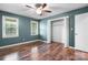Empty bedroom features two windows, hardwood floors, and closet at 139 Pleasant Garden Dr, Taylorsville, NC 28681