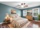 This staged bedroom features hardwood floors, two windows, and bright colored decorations at 139 Pleasant Garden Dr, Taylorsville, NC 28681