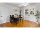 This dining room features a decorative sign, wooden floors, seating for four, and double doors at 139 Pleasant Garden Dr, Taylorsville, NC 28681