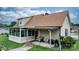 Back exterior view showcases a sunroom, covered patio, and well-kept lawn, enhancing the home's outdoor living appeal at 139 Pleasant Garden Dr, Taylorsville, NC 28681