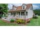 Charming home featuring a welcoming front porch, manicured landscaping, and classic architectural details at 139 Pleasant Garden Dr, Taylorsville, NC 28681