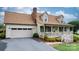 Inviting home with an attached garage, classic curb appeal, and a charming front porch at 139 Pleasant Garden Dr, Taylorsville, NC 28681