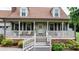 Charming front porch featuring a welcoming entrance and beautiful landscaping at 139 Pleasant Garden Dr, Taylorsville, NC 28681