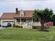Charming single-Gathering home with a welcoming front porch, lush lawn, and attached garage at 139 Pleasant Garden Dr, Taylorsville, NC 28681