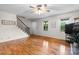 Bright living room showcasing hardwood floors, a staircase, and large windows for natural light at 139 Pleasant Garden Dr, Taylorsville, NC 28681